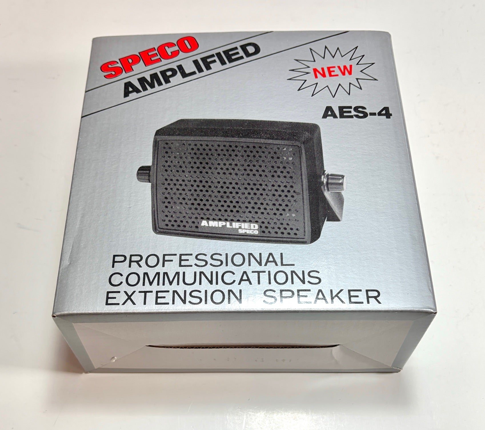 Box of a Speco Amplified professional communications extension speaker on a white background